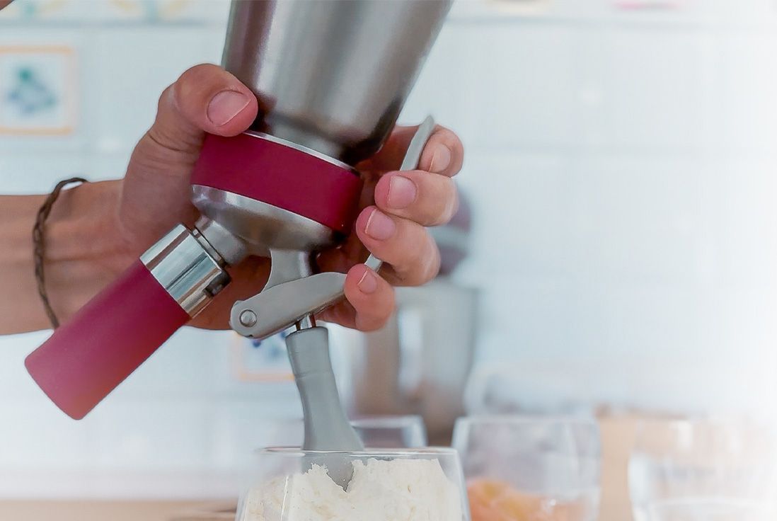 Image de l'utilisation d'un siphon Gobel pour mettre de la chantilly dans une verrine