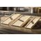 Gamme de trois mandolines de cuisine professionnelles Benriner beiges de différentes tailles disposées sur un plan de travail.